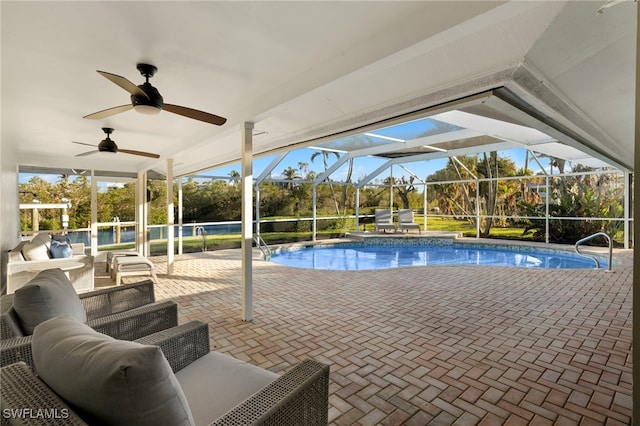 view of swimming pool featuring an outdoor living space, glass enclosure, and a patio area