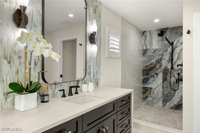 bathroom with vanity and tiled shower