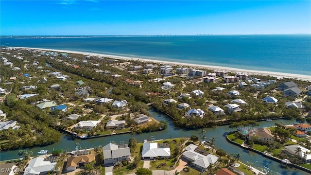 drone / aerial view with a water view and a beach view