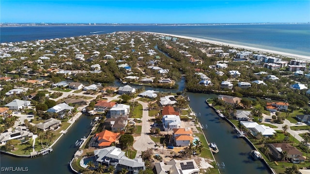 birds eye view of property featuring a view of the beach and a water view