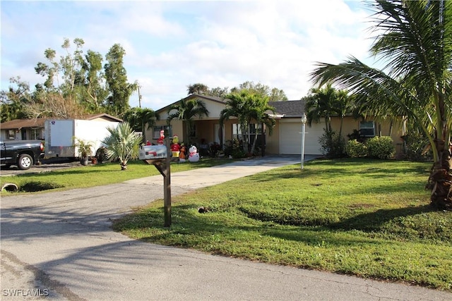 ranch-style house with a garage and a front yard