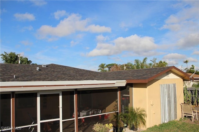 view of side of home with a sunroom