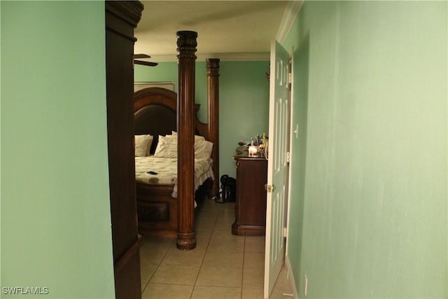 corridor with light tile patterned floors and crown molding