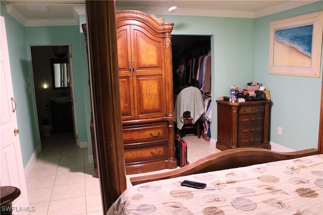 tiled bedroom featuring a closet and ornamental molding