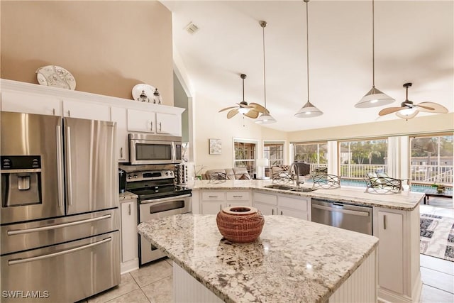 5471 Harborage Dr, Fort Myers, FL 33908 - kitchen featuring a peninsula, ceiling fan, a sink, stainless steel appliances, and a center island