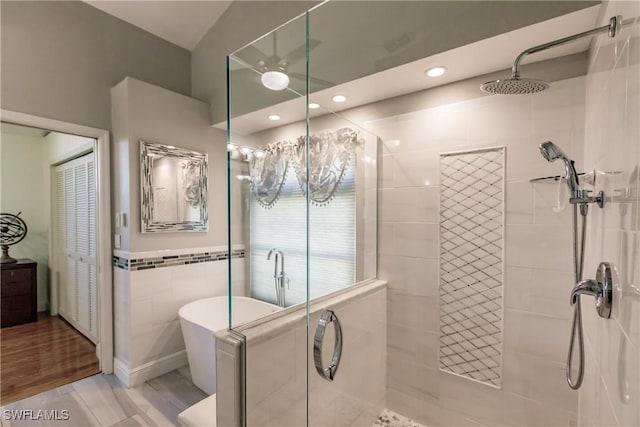 5471 Harborage Dr, Fort Myers, FL 33908 - full bath with a soaking tub, a shower stall, and tile walls