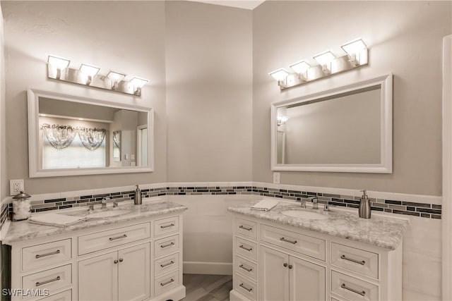 bathroom featuring vanity and tile walls