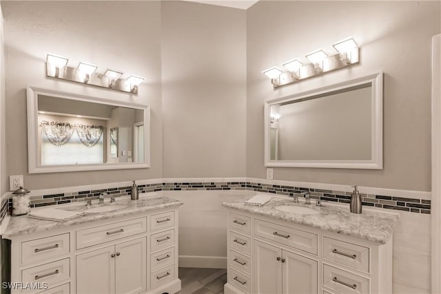 5471 Harborage Dr, Fort Myers, FL 33908 - bathroom featuring tile walls, two vanities, and a sink