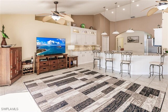 5471 Harborage Dr, Fort Myers, FL 33908 - kitchen with light tile patterned floors, a kitchen bar, and ceiling fan