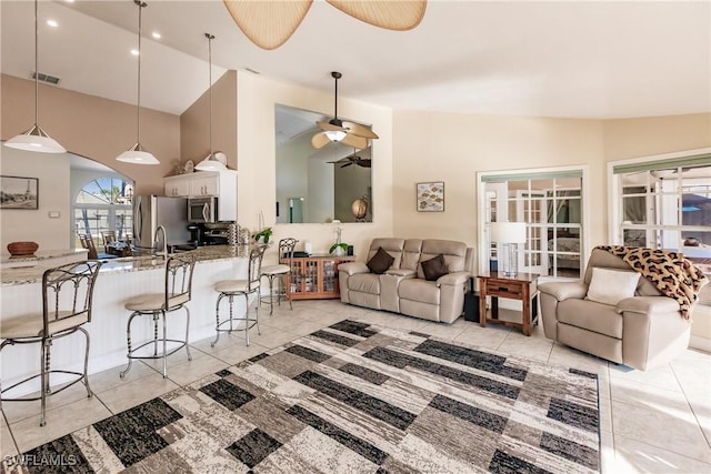 living area with lofted ceiling, light tile patterned floors, recessed lighting, visible vents, and a ceiling fan