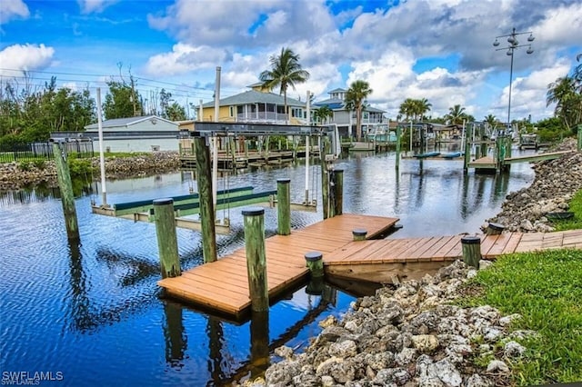5471 Harborage Dr, Fort Myers, FL 33908 - dock area with boat lift, a residential view, and a water view