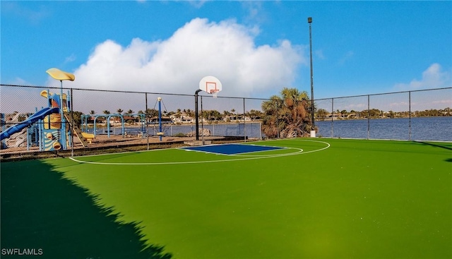 view of sport court featuring community basketball court, playground community, and fence