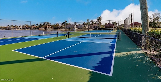 view of sport court with a water view