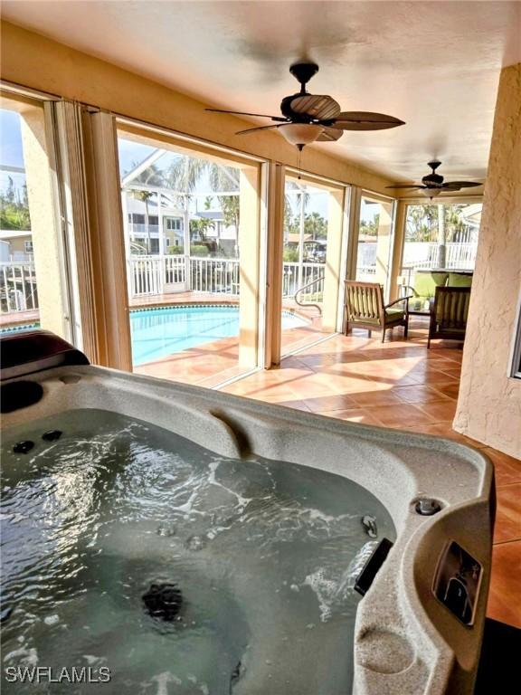 5471 Harborage Dr, Fort Myers, FL 33908 - exterior space with ceiling fan, a swimming pool, glass enclosure, an indoor hot tub, and a patio area