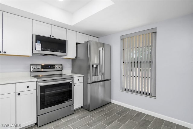 kitchen with stainless steel appliances and white cabinets