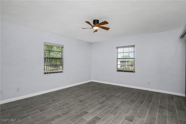 unfurnished room with dark hardwood / wood-style flooring, a wealth of natural light, and ceiling fan