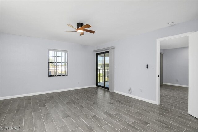 spare room with dark hardwood / wood-style floors and ceiling fan