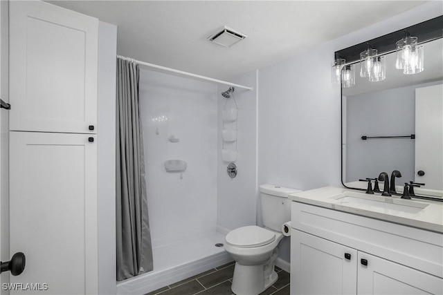 bathroom with vanity, a shower with curtain, and toilet