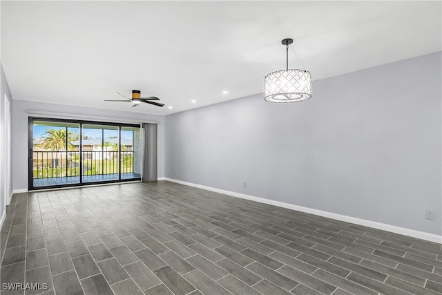 empty room featuring dark hardwood / wood-style floors and ceiling fan