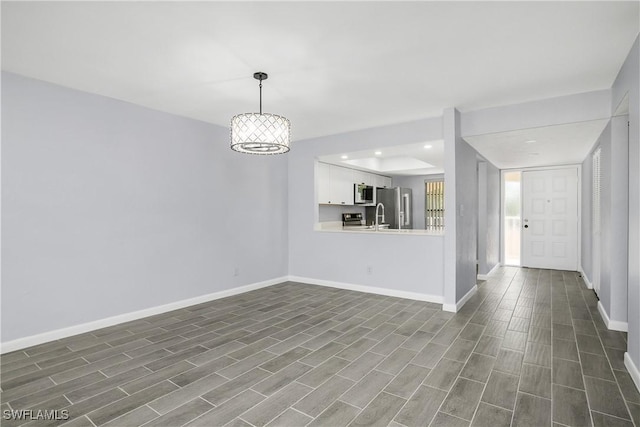 unfurnished living room with dark hardwood / wood-style floors and sink