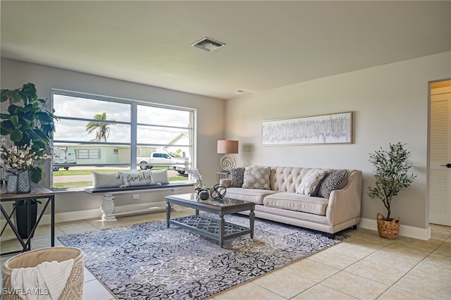 living room with a wealth of natural light and light tile patterned floors