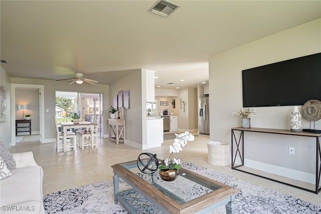 living room featuring ceiling fan and light tile patterned flooring