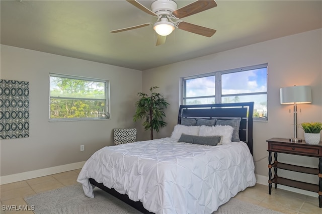 bedroom with ceiling fan and light tile patterned floors