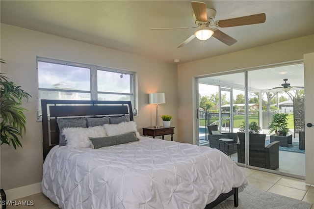 bedroom featuring access to exterior, ceiling fan, light tile patterned floors, and multiple windows