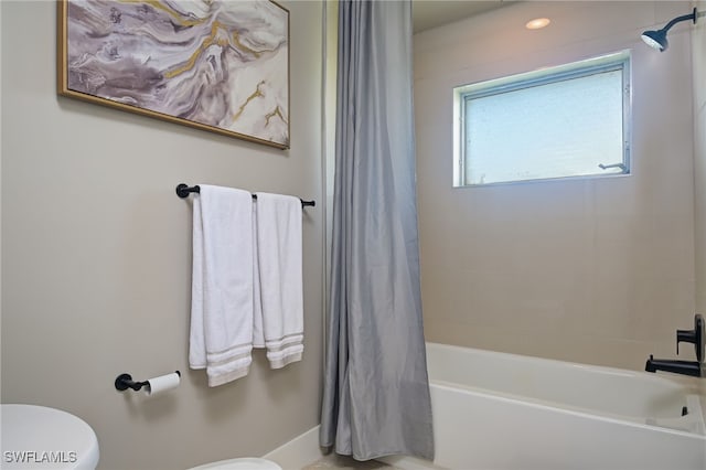 bathroom with shower / tub combo and toilet