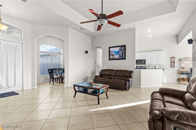 living room featuring ceiling fan and light tile patterned flooring