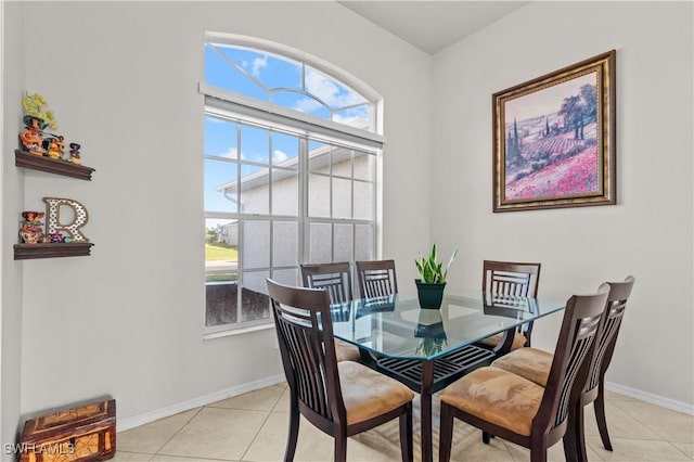 tiled dining space featuring a healthy amount of sunlight