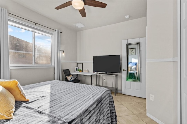 tiled bedroom featuring ceiling fan