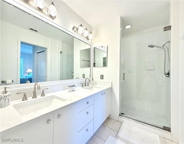 bathroom featuring tile patterned flooring, vanity, and an enclosed shower