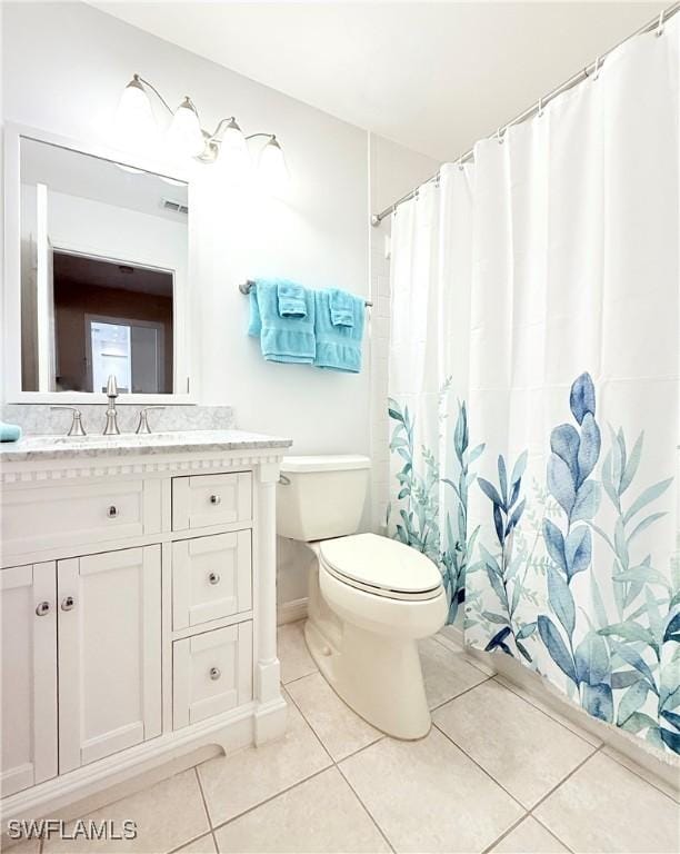 bathroom with tile patterned floors, vanity, and toilet