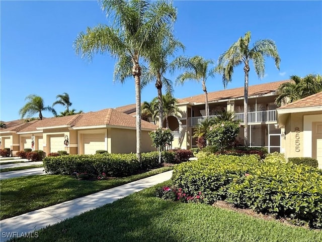 view of front of home with a front yard and a garage