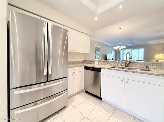 kitchen with sink, ornamental molding, light stone counters, white cabinetry, and stainless steel appliances