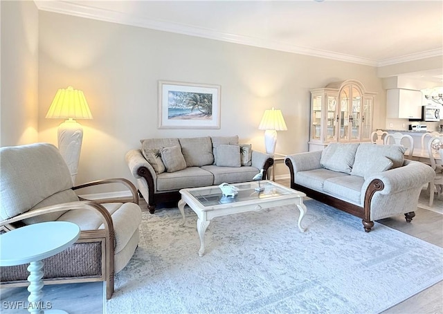 living room with light wood-type flooring and crown molding