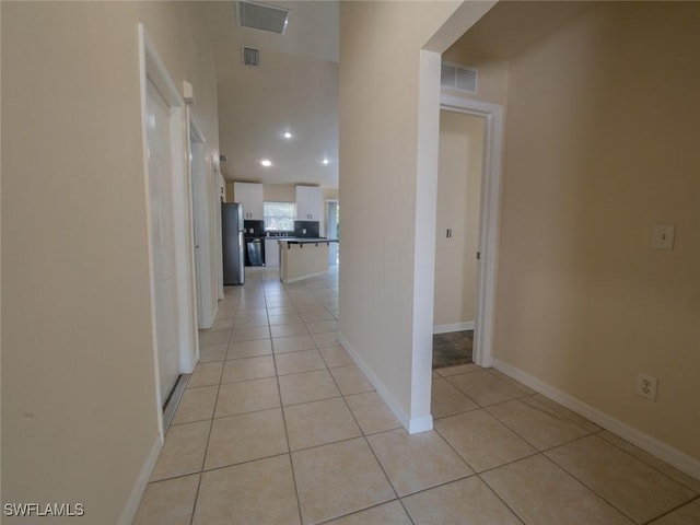 corridor featuring light tile patterned floors