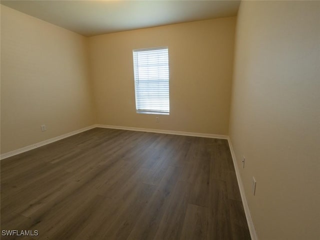 spare room with dark wood-type flooring