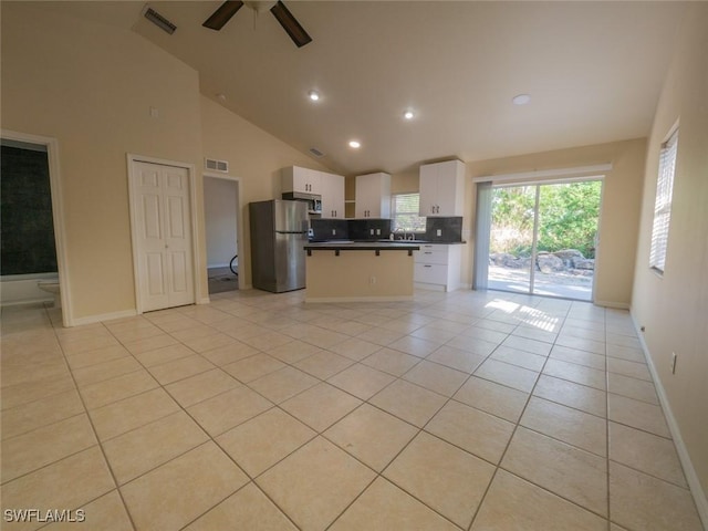 kitchen featuring appliances with stainless steel finishes, ceiling fan, sink, light tile patterned floors, and white cabinets