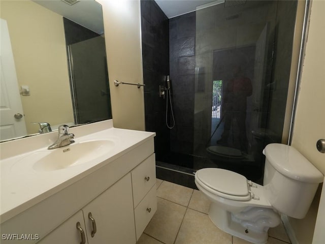 bathroom featuring tile patterned floors, vanity, walk in shower, and toilet