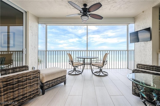 sunroom featuring ceiling fan