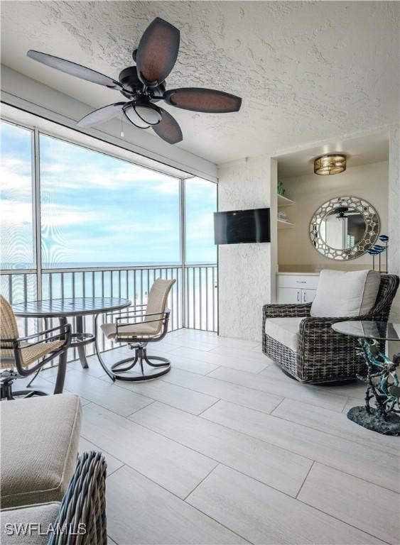 sunroom with a wealth of natural light and ceiling fan