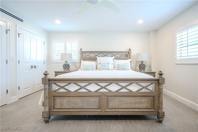 carpeted bedroom with multiple windows and ceiling fan