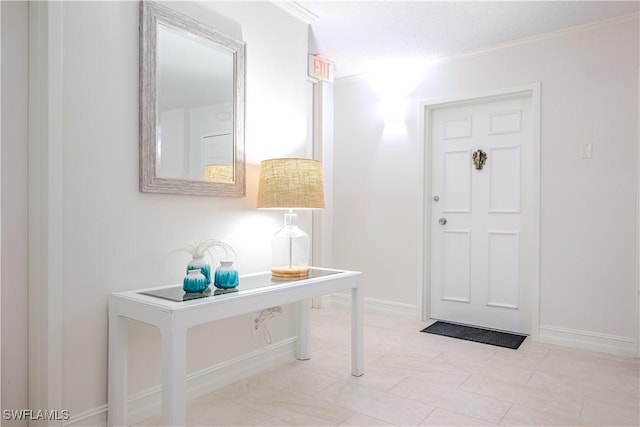 doorway to outside featuring a textured ceiling and ornamental molding