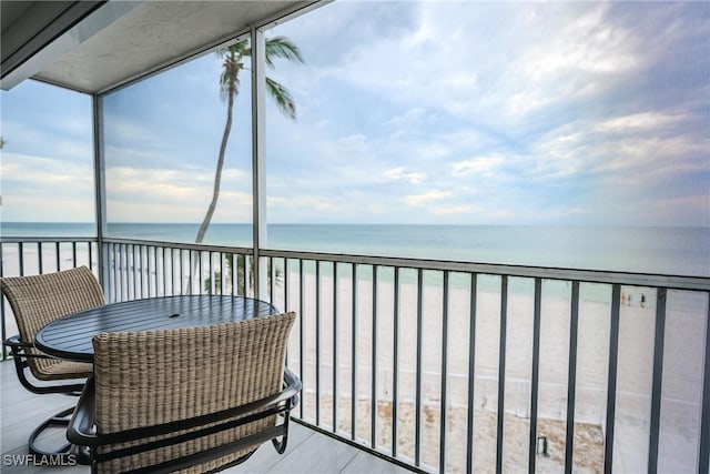 balcony featuring a water view and a view of the beach