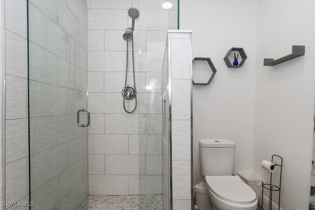 bathroom with toilet and an enclosed shower