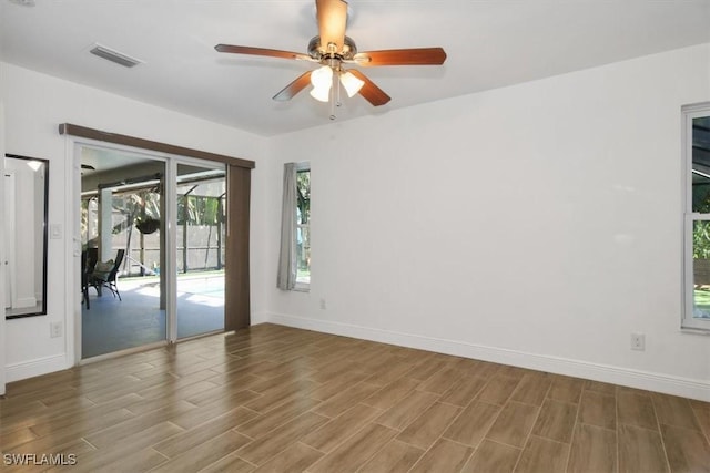 empty room featuring hardwood / wood-style flooring and ceiling fan