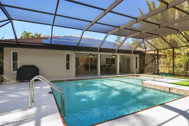 view of swimming pool featuring ceiling fan, area for grilling, a lanai, and a patio