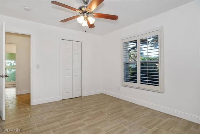 unfurnished bedroom featuring ceiling fan and a closet